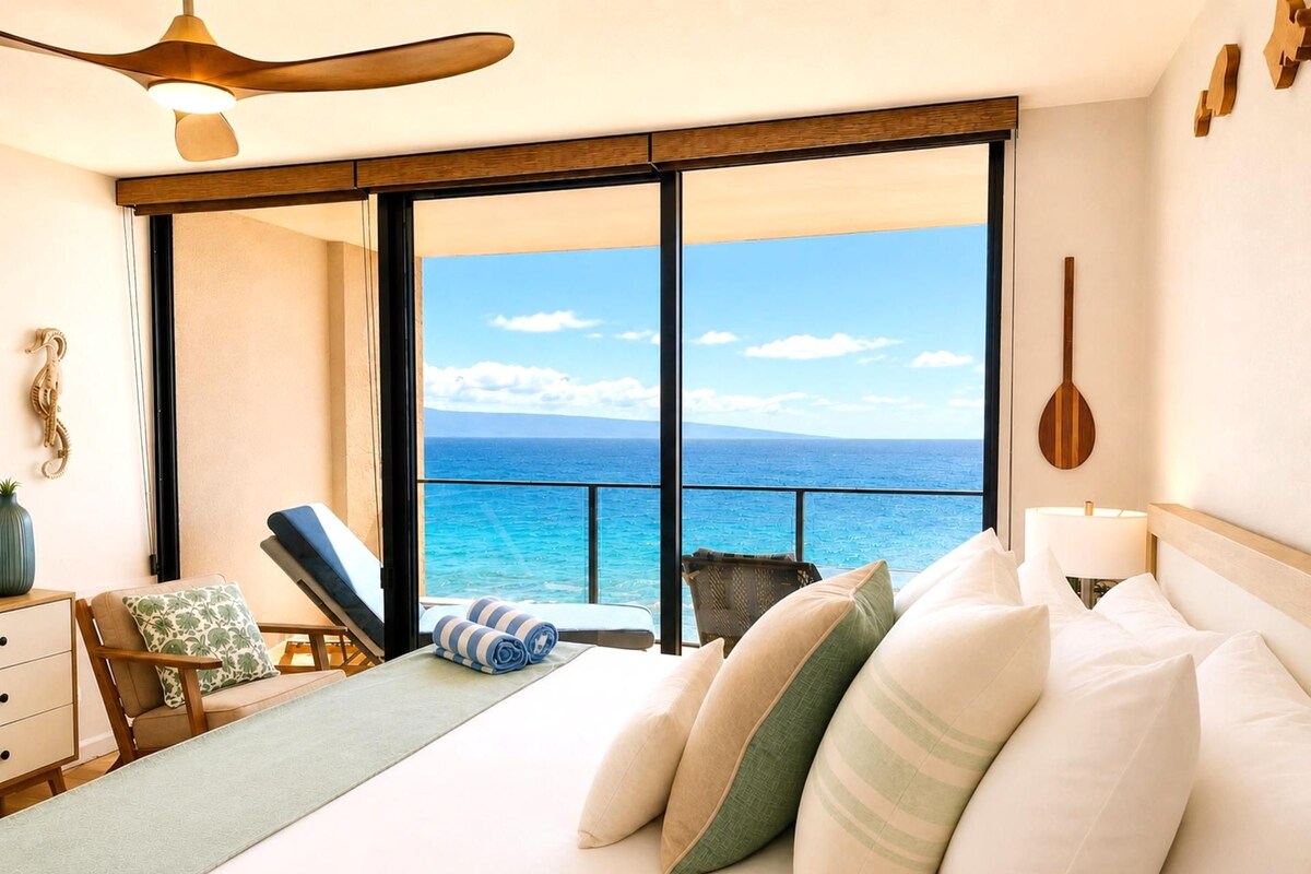 A bedroom with a large window, a bed, a chair, and a ceiling fan.