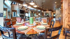 A spacious dining area with a wooden table set for six, surrounded by dark wooden chairs. - Rossi Hill 4 Bedrooms PRH-685 by KBM (Park City)