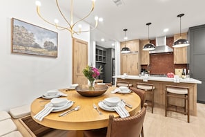 A modern kitchen with a central island, wooden cabinets, and pendant lighting. - Lift Lodge 2 Bedrooms LLC103 by KBM (Park City)
