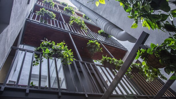 A multi-story building with balconies, some with plants. - Incredible 2 Bedroom Apartment at El Rastro (Madrid)
