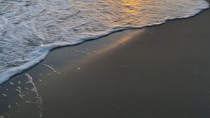 A beach with waves at sunset. - Bayfront, kayaks, private dock, 5 minute walk to the Gulf (Gulf Shores)
