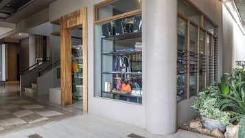 A modern interior with a staircase, a wooden sign, and a glass display case with items.