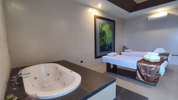 Bathroom features a bathtub, two separate washbasins, and a large mirror.