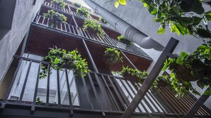 A multi-story building with balconies, some with plants. - Incredible 1 bedroom apartment at El Rastro (Madrid)