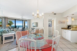 Enjoy meals around the central dining table with ocean views.