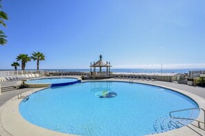 Relax by the pool surrounded by a paved deck and gazebo, with the ocean views just steps away.