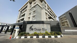 A modern multi-story building with a prominent entrance and a sign reading "Ocean Blue". - Ocean Blue Studios (Cairo)