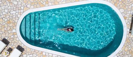 Seasonal outdoor pool, pool umbrellas, pool loungers