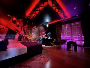A modern hotel room with a large bed, a desk, and a view of the cityscape through large windows. - My Music Hotel (Baku)