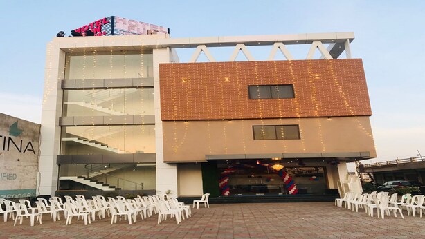A hotel with a modern design, featuring a brick facade, large windows, and a staircase leading to an upper level. - Hotel Fun Imperial Morbi (Morbi)