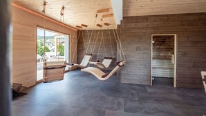 A modern interior with a wooden ceiling, dark flooring, and a view of the outdoors through large windows. - stuub todtnauberg (Todtnau)