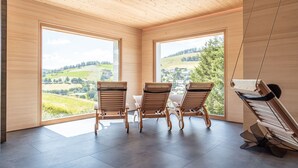 A room with large windows, wooden ceiling, and a table with chairs. - stuub todtnauberg (Todtnau)