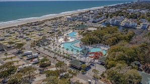 An aerial view of a coastal resort with a large swimming pool, RV parking, and beachfront access. - Please welcome "Two Hands Excited" to the Ocean Lakes rental program. (Myrtle Beach)