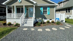 A two-story house with a porch, a front door, and a mailbox. - Josie's Getaway - Pet Friendly -Mini-Vacations and Month to Monthly Available (Chincoteague)