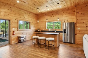 Enjoy cooking in this cozy kitchen with a central island and stainless steel appliances.