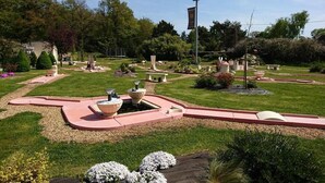 A well-maintained garden with a winding path, a central water feature, and various seating areas. - Family chateau in the heart of an estate (Flacey)