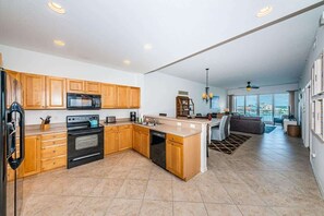 A modern kitchen with wooden cabinets, a built-in oven, and a dishwasher.