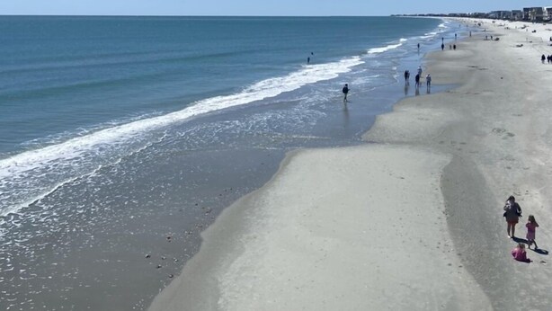 A beach with a wide sandy shore, calm sea, and clear sky. - Garden City Beach- Great Location! 2 minute walk to beach and pier! Sleeps 6.  (Murrells Inlet)
