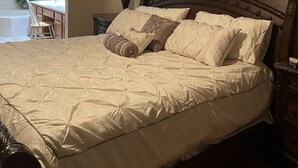 A bedroom with a large bed, a nightstand, a lamp, and two framed pictures on the wall. - Fully remodeled 3000sf .home with 3 bedrooms plus  and 2.5 bathrooms  (AURORA)