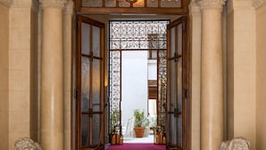 A grand entrance with a red carpet leading to a door labeled "NOLENSKI." - Nolinski Venezia - Evok Collection (Venice)