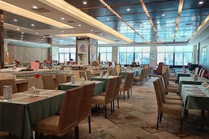A spacious dining area with multiple tables and chairs, large windows, and a modern ceiling design. - Landscape Hotel (Zhangping)