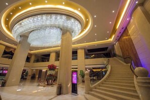 A spacious lobby with a grand chandelier, multiple staircases, and a central floral arrangement. - Landscape Hotel (Zhangping)