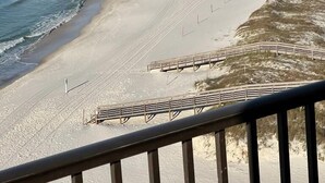 A beach with a wooden boardwalk, sandy beach, and ocean waves. - SOPHISTICATED BEACHFRONT RETREAT -  New Furniture & Decor!! (Orange Beach)