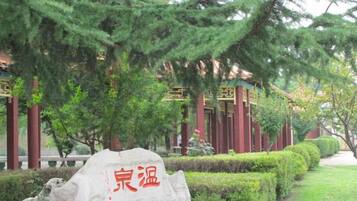 A traditional Chinese building with a stone marker in front.