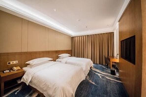 A hotel room with two beds, a desk, a telephone, and a television. - Jincheng Hot Spring Hotel (Zhaoyuan)