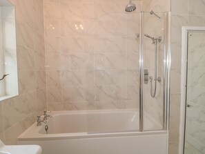 A modern bathroom with a glass-enclosed shower, a standalone bathtub, and a toilet. - West Ridge (Bournemouth)