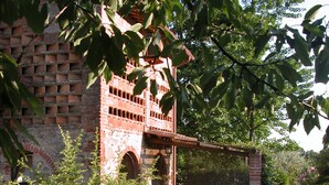 A brick building with a stone pathway leading to a wooden structure. - Romantic independent country house with garden, between Lucca and Florence (Toscana)