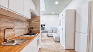 A modern kitchen with white cabinets, a wooden countertop, and a stainless steel sink. - [3 bathroom] Lovely Apartment in the Vatican, close to Castel Sant'Angelo (Roma)