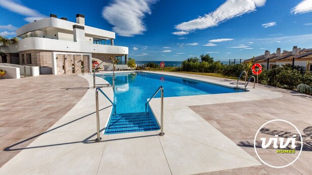 A modern pool area with a clear view of the sea, a lifebuoy, and a sign indicating no swimming. - Blue View | sea view - garden - pool (Mijas Costa)