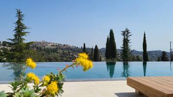 Seasonal outdoor pool, open 7:00 AM to 10:30 PM, pool umbrellas