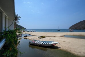 A beach with boats, a clear sky, and a hilly landscape in the background. - Casa Dos Aguas: Yelapa Beachfront 1BR with Bay Views & Open-Air Terrace (Yelapa)