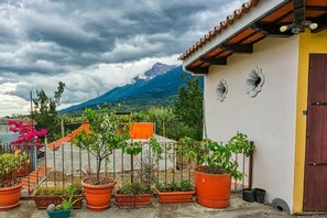 Enjoy a peaceful retreat with a balcony overlooking the surrounding mountains.