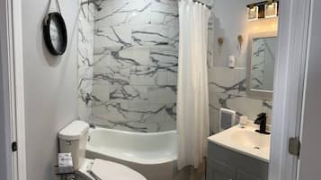 Combined shower/bathtub, hair dryer, towels, soap