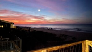 A coastal sunset view with a wooden deck and a building in the foreground. - Eagle's Nest - Beautiful House close to boat launch and local attractions.  (Russellville)