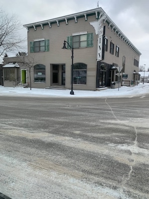 Stylish building with a flat facade and green shutters, offering a charming storefront experience.
