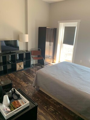 Relax in a stylish room with a large bed, flat-screen TV, and comfortable seating area.