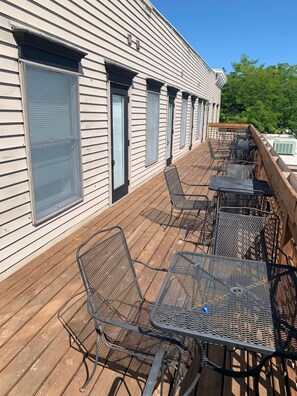 Enjoy outdoor dining or relaxation on the deck with comfortable seating and tables.