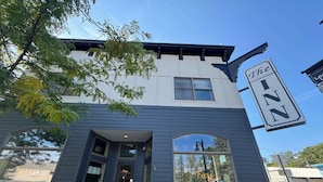 A building with a sign reading "The Inn" and a large arched window.