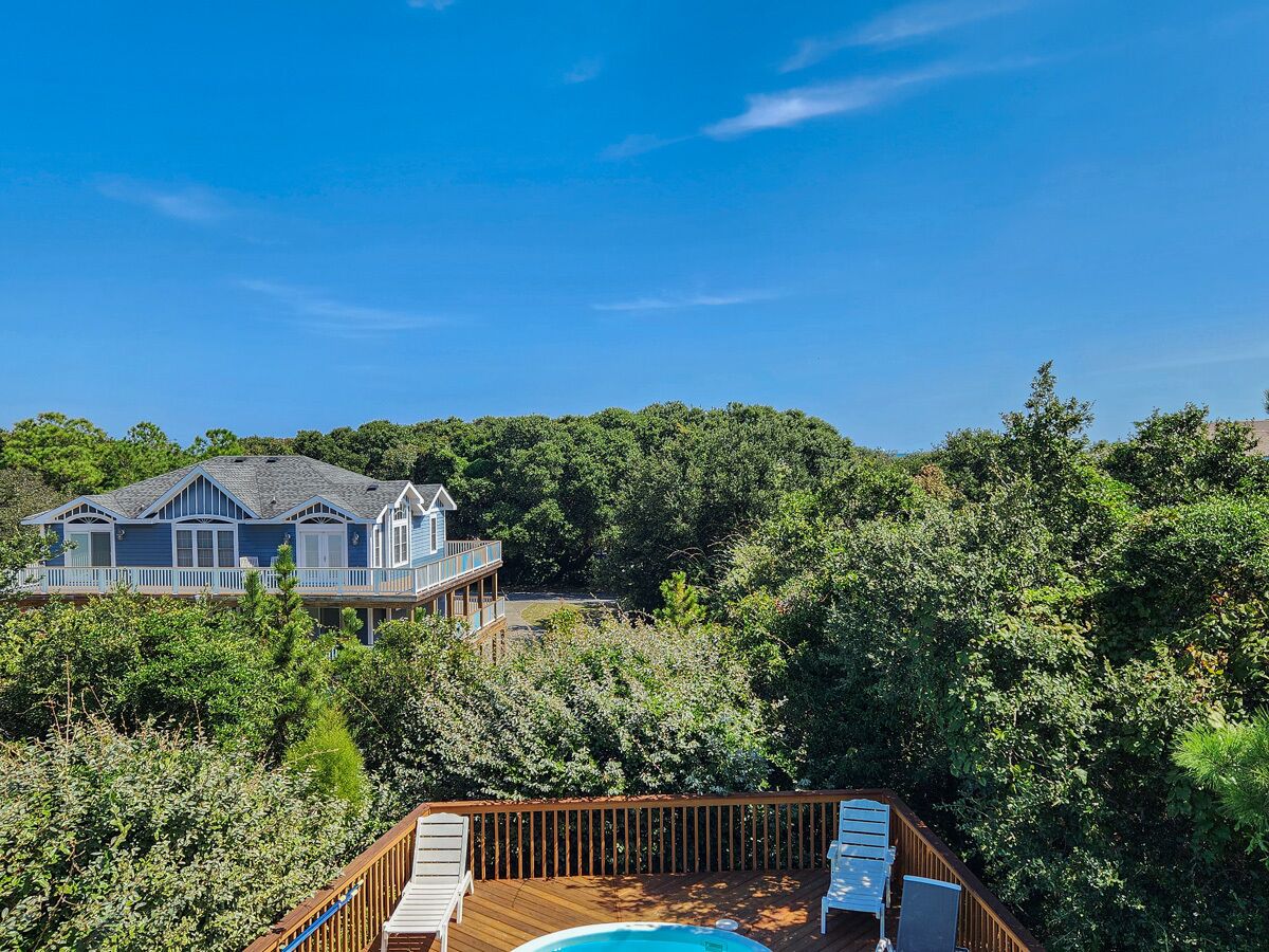 A house with a large deck and a swimming pool.