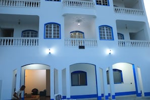 A multi-story building with balconies, arched doorways, and a central decorative element. - Orient star hotel (Luxor)