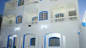 A multi-story building with balconies, large windows, and a swimming pool. - Orient star hotel (Luxor)