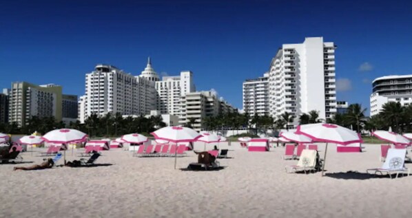 Relax on the beach with comfortable lounge chairs and umbrellas.
