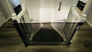A staircase with a glass barrier, wooden steps, and white railings. - Colorful Shadow-Game Rm, Hot Tub, 5 min from Chisholm Creek (Oklahoma City)