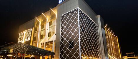 A modern hotel with a prominent 'Best Western' sign, large windows, and a geometric facade design.