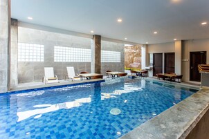 Indoor pool, open 9:00 AM to 5:00 PM, pool umbrellas