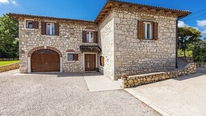A stone house with a large wooden door and two windows with shutters. - Stone Gem - Villa Katarina with Private Pool (Nedešcina)